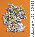 Miniature cityscape shaped as Germany map on flat background - ai generated 138423888