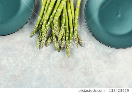 Spring green asparagus bunch on kitchen background Spring green asparagus bunch on kitchen background 138423939