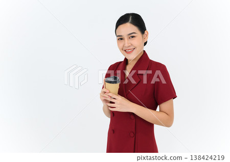Look at the camera for a portrait of a young businesswoman posing with paper cup of coffee or tea, isolated on white background. Achievement career wealth business concept Look at the camera for a portrait of a young businesswoman posing with paper cup of coffee or tea, isolated on white background. Achievement career wealth business concept 138424219
