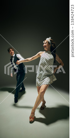 Retro style couple dancing lindy hop in polka dot dress vintage fashion scene Retro style couple dancing lindy hop in polka dot dress vintage fashion scene 138424723