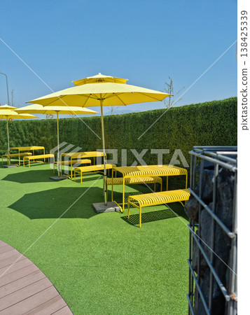 It is an outdoor cafe with parasols. It is an outdoor cafe with parasols. 138425339