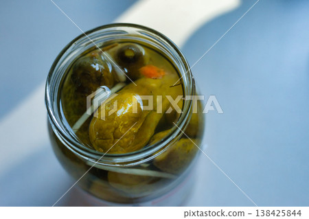 An open jar of pickled cucumbers 138425844