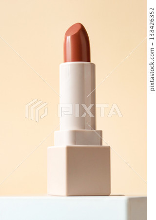 Red lipstick isolated on beige background. 138426352