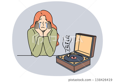 Woman cries while listening to music on vinyl player, due to nostalgia and memories of happy past Woman cries while listening to music on vinyl player, due to nostalgia and memories of happy past 138426419