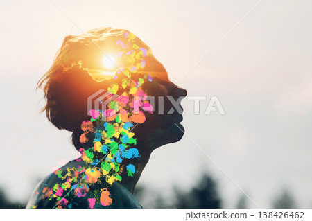 Transgender man queer with sun and rainbow colors inside his head. Pride and freedom love concept. Silhouette portrait. 138426462