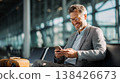 Businessman Uses Smartphone for  Business for Traveling at airport. 138426673