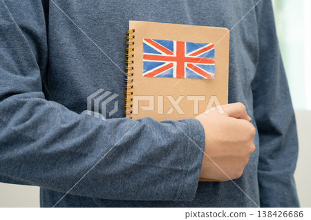Learn English language, Asian teenage student hold book with flag in course at school. 138426686