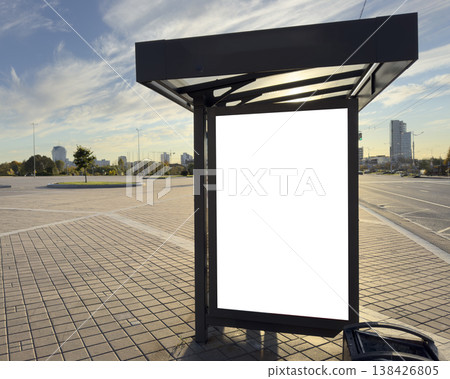 Blank advertising poster displayed at a city bus stop on an urban street. Empty vertical signboard Blank advertising poster displayed at a city bus stop on an urban street. Empty vertical signboard 138426805