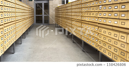 Archive interior with rows of vintage boxes and document storage in a museum or library setting. Archive interior with rows of vintage boxes and document storage in a museum or library setting. 138426806