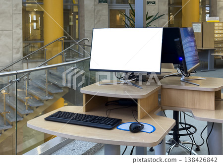office workspace with desktop computer screen mockup and keyboard on desk. Blank display creates 138426842