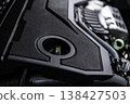 Engine oil filler cap in modern car engine bay close-up of oil cap for maintenance and service 138427503