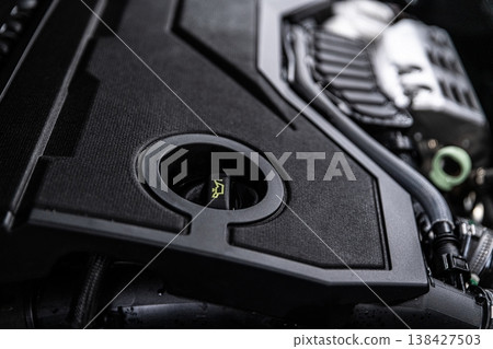 Engine oil filler cap in modern car engine bay close-up of oil cap for maintenance and service Engine oil filler cap in modern car engine bay close-up of oil cap for maintenance and service 138427503
