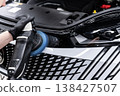 Car paint correction process with polishing machine in detailing studio removing scratches and restoring gloss 138427507