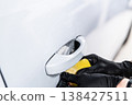 Applying PPF film on car door handle area protection against scratches in detailing studio close-up 138427511