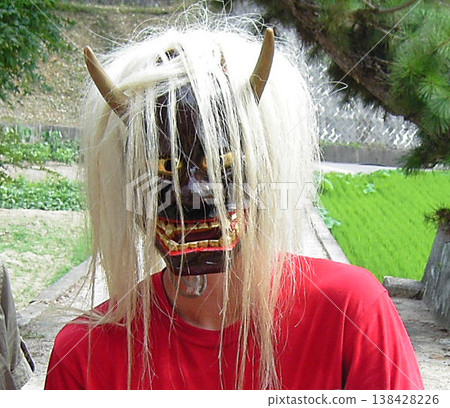 A close-up of a person wearing a demon mask at a festival in Mihara City, Hiroshima Prefecture. A close-up of a person wearing a demon mask at a festival in Mihara City, Hiroshima Prefecture. 138428226
