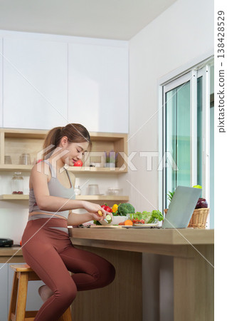 Woman chopping vegetables in a bright kitchen Woman chopping vegetables in a bright kitchen 138428529