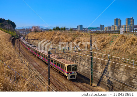 A view of Mt. Fuji and plum blossoms, trains, and high-rise apartments in Inagi City, Tokyo, in spring. A view of Mt. Fuji and plum blossoms, trains, and high-rise apartments in Inagi City, Tokyo, in spring. 138428691