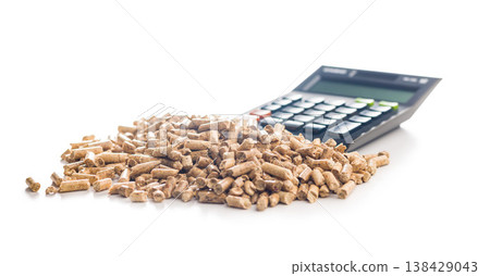 Calculator on Pile of Wood Pellets Representing Biofuel Cost, Renewable Energy Accounting and Fuel Efficiency Analysis Calculator on Pile of Wood Pellets Representing Biofuel Cost, Renewable Energy Accounting and Fuel Efficiency Analysis 138429043