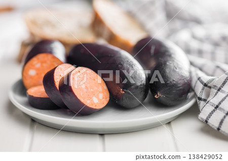 Smoked Blood Sausage Sliced on Plate with Bread and Kitchen Towel in Rustic Style Smoked Blood Sausage Sliced on Plate with Bread and Kitchen Towel in Rustic Style 138429052