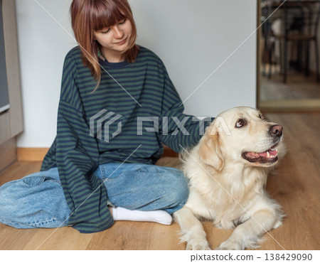 Young girl enjoying time with her golden retriever dog Young girl enjoying time with her golden retriever dog 138429090