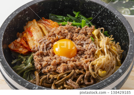 The bibimbap just before it's finished. The bibimbap just before it's finished. 138429185
