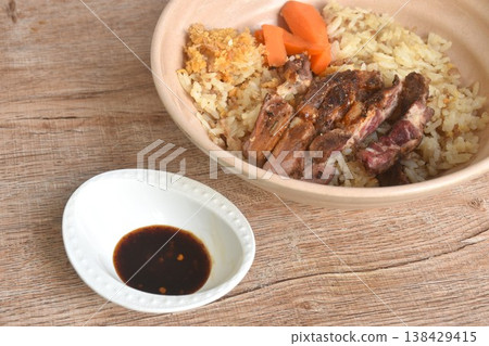 grilled slice beef meat on fried rice and carrot on bowl dipping Thai spicy chili with tamarind sauce grilled slice beef meat on fried rice and carrot on bowl dipping Thai spicy chili with tamarind sauce 138429415
