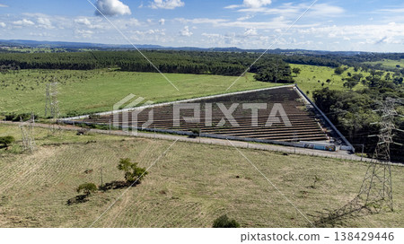 Panoramic aerial view of triangular solar farm and power grid Panoramic aerial view of triangular solar farm and power grid 138429446