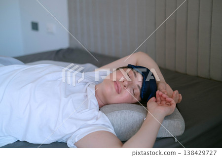 Orthopedic pillow reduces neck discomfort as woman rests in a calm setting and cares for health and sleep quality better 138429727
