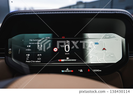 Close up of a digital instrument cluster shows 0 kmh in Park, trip data, and a 3D map with V16 and Maza iela in Latvia, 8 C at 14 46, odometer 32342 km, and status icons Close up of a digital instrument cluster shows 0 kmh in Park, trip data, and a 3D map with V16 and Maza iela in Latvia, 8 C at 14 46, odometer 32342 km, and status icons 138430114