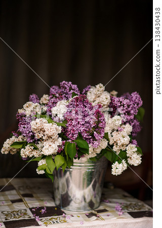 Bouquet of lilacs in a bucket on the table 138430438