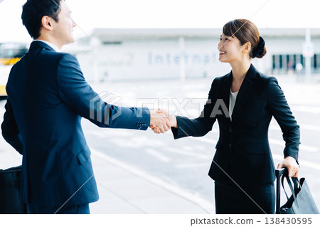 A woman and a man shake hands as a business greeting. (Photo courtesy of Kansai International Airport (KIX)) 138430595