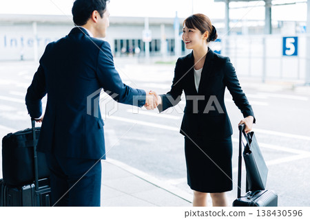 A woman and a man shake hands as a business greeting. (Photo courtesy of Kansai International Airport (KIX)) 138430596
