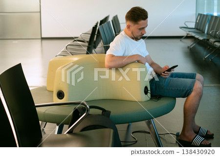 Modern airport offers maximum comfort with built in charging stations in seats helping traveler stay productive while waiting for flight Modern airport offers maximum comfort with built in charging stations in seats helping traveler stay productive while waiting for flight 138430920