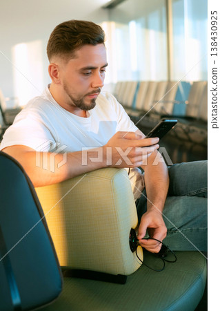 Airport waiting area as a workspace with built in charging allowing man to stay connected and complete tasks while traveling without limits 138430925