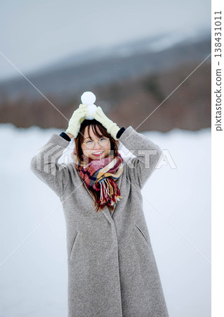 一位年輕女子抱著一個雪人 138431011