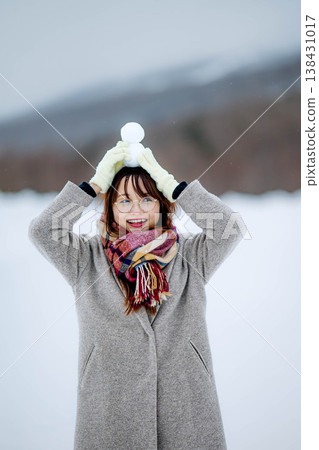 A young woman holding a snowman 138431017