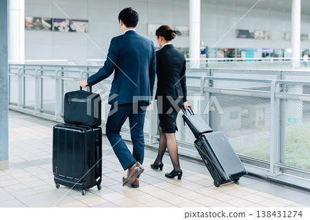A woman and a man in suits on a business trip. (Photo courtesy of Kansai International Airport (KIX)) A woman and a man in suits on a business trip. (Photo courtesy of Kansai International Airport (KIX)) 138431274