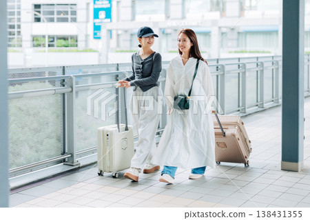 Two women at the airport departing for an overseas trip. (Photo courtesy of Kansai International Airport (KIX)) Two women at the airport departing for an overseas trip. (Photo courtesy of Kansai International Airport (KIX)) 138431355