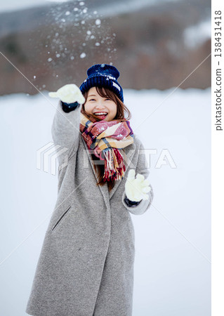 Young women playing in the snow Young women playing in the snow 138431418