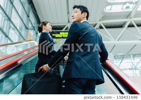 兩名男女空服人員正在機場搭乘自動扶梯。 （圖片由關西國際機場（KIX）提供） 138431496