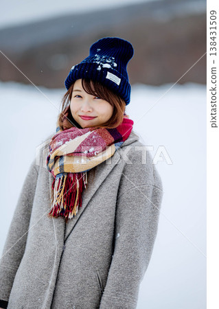 Smiling woman standing on snow Smiling woman standing on snow 138431509