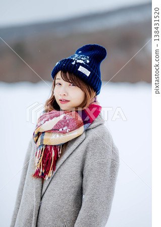 Smiling woman standing on snow Smiling woman standing on snow 138431520
