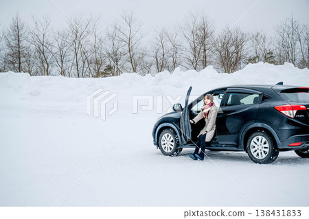 A young woman in a car in the winter snow A young woman in a car in the winter snow 138431833