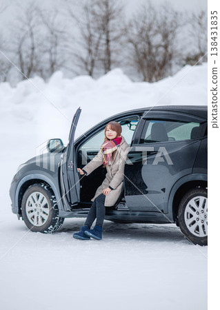 A young woman in a car in the winter snow A young woman in a car in the winter snow 138431835