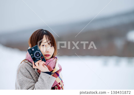 A young lady with a camera A young lady with a camera 138431872