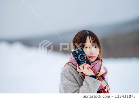 A young lady with a camera A young lady with a camera 138431873