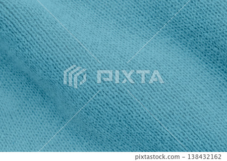 Macro photo of thick blue knitwear with a classic cable stitch pattern. The soft, textured yarn creates a cozy aesthetic with expressive shadows and rich azure tones Macro photo of thick blue knitwear with a classic cable stitch pattern. The soft, textured yarn creates a cozy aesthetic with expressive shadows and rich azure tones 138432162