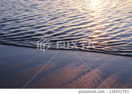 Gentle waves lapping against the sandy shore of the lagoon, and the water's surface sparkling in the morning sun. Gentle waves lapping against the sandy shore of the lagoon, and the water's surface sparkling in the morning sun. 138432763