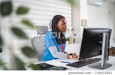 Healthcare professional working on computer in modern office 138432801