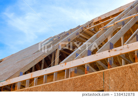 Roofing frame trusses on wood beams framing for new house while build process Roofing frame trusses on wood beams framing for new house while build process 138432878